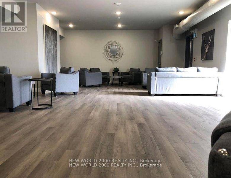 A living room with a white couch and a wooden floor.
