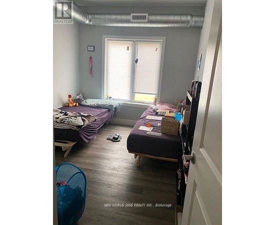 A bedroom with two beds and a window.