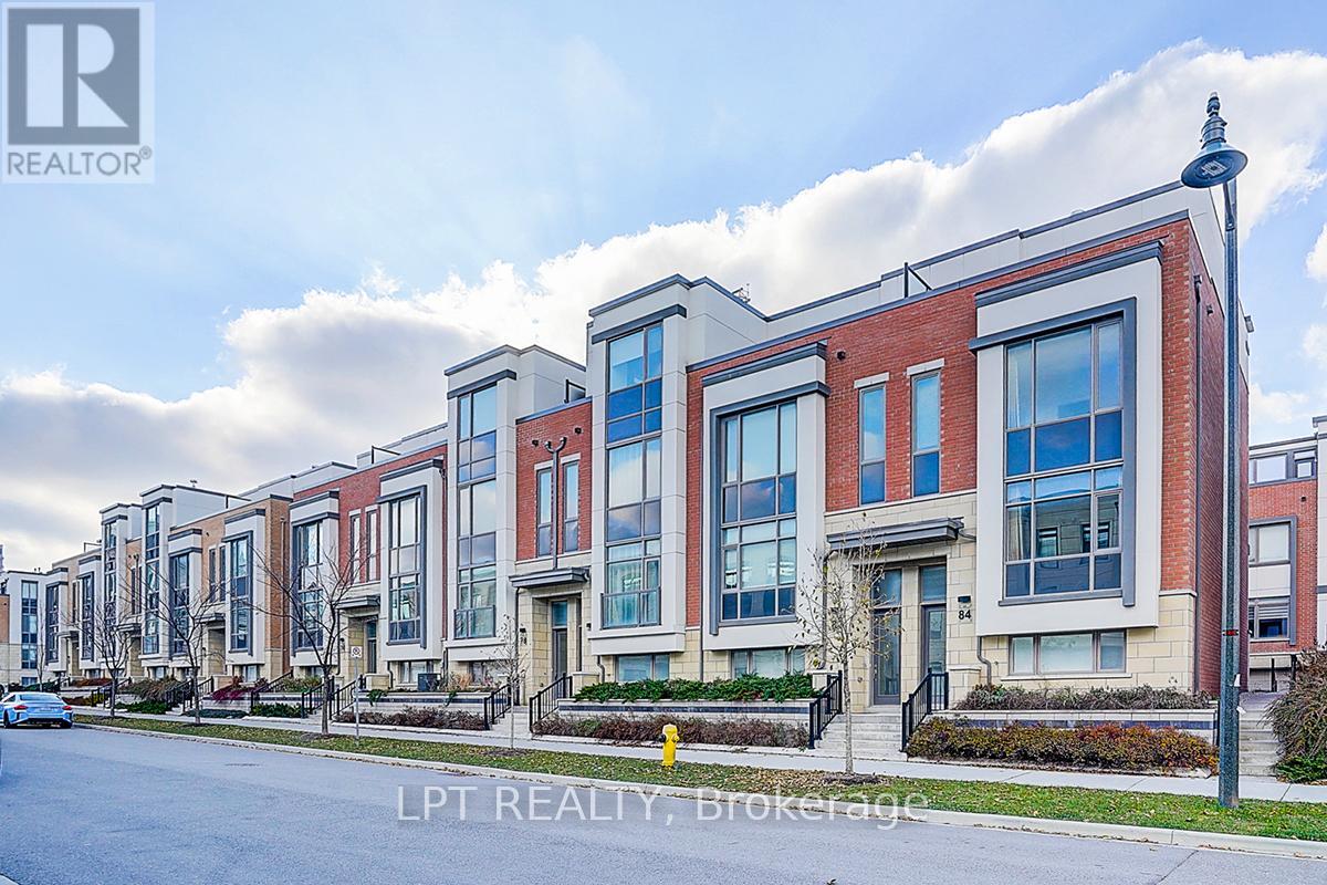 A row of modern townhouses with a clear sky in the background.