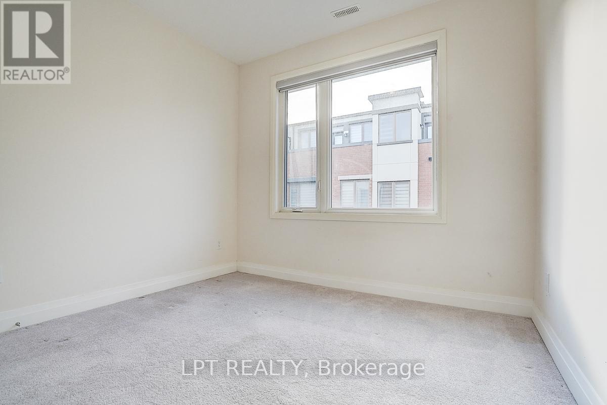 A room with a window showing a view of a building outside.