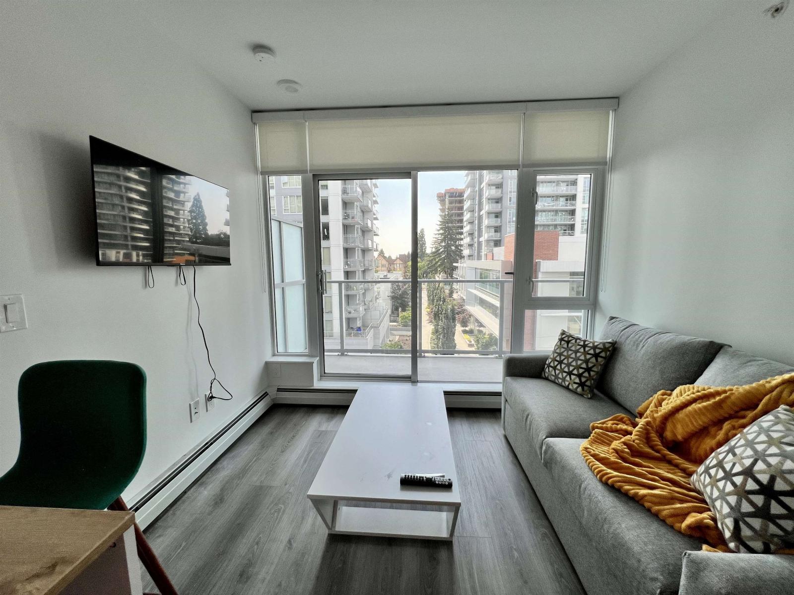 A living room with a grey couch and a white coffee table.