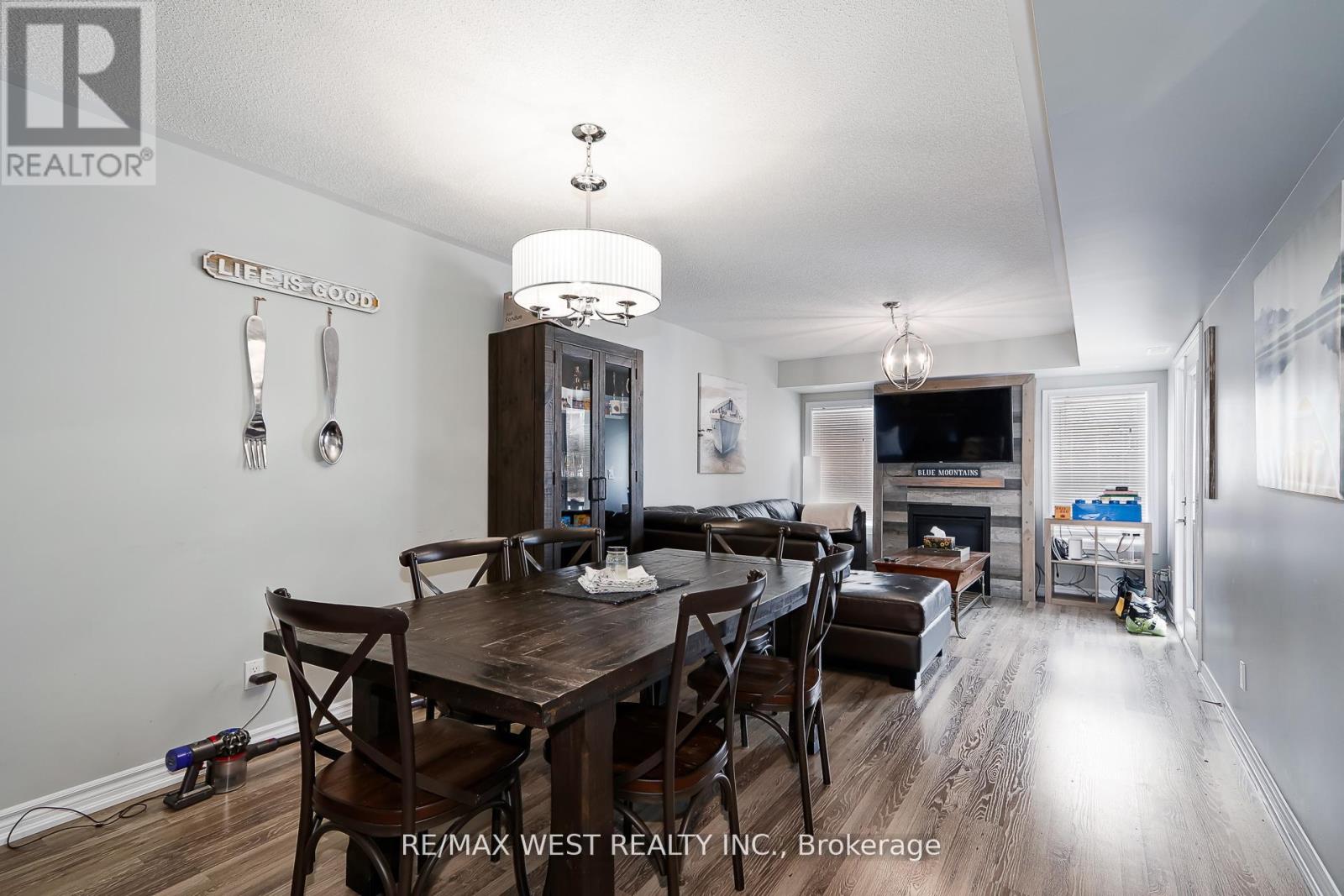 A dining room with a wooden table and chairs.
