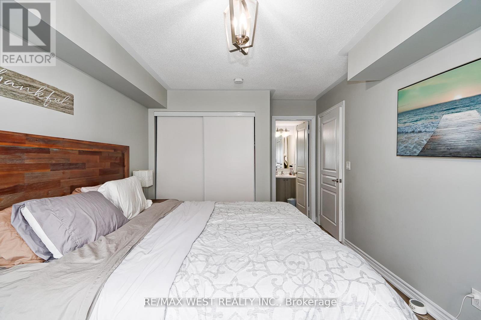 A bedroom with a large bed and a wooden headboard.