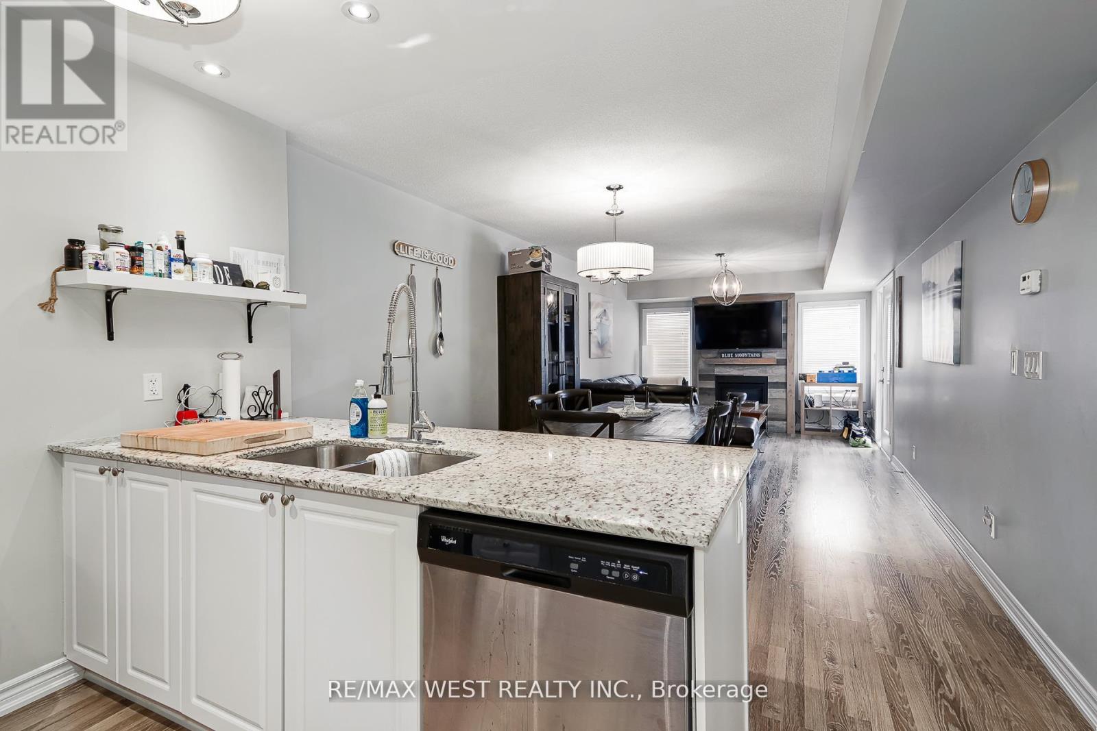 A kitchen with white cabinets and a granite countertop.