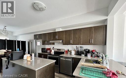 A kitchen with a stove top oven and a dishwasher.