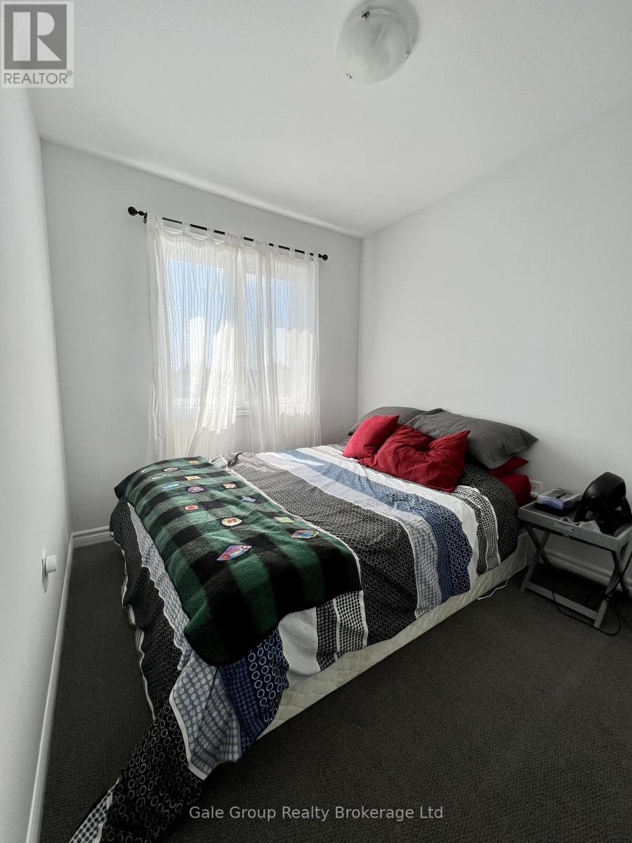 A bedroom with a bed covered in blankets and pillows.