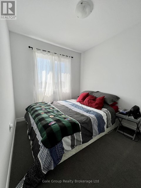 A bedroom with a bed covered in blankets and pillows.