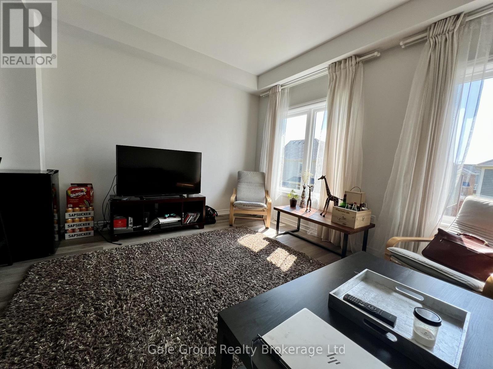 A living room with a television, a sofa, and a coffee table.