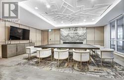 A conference room with a long table and chairs.