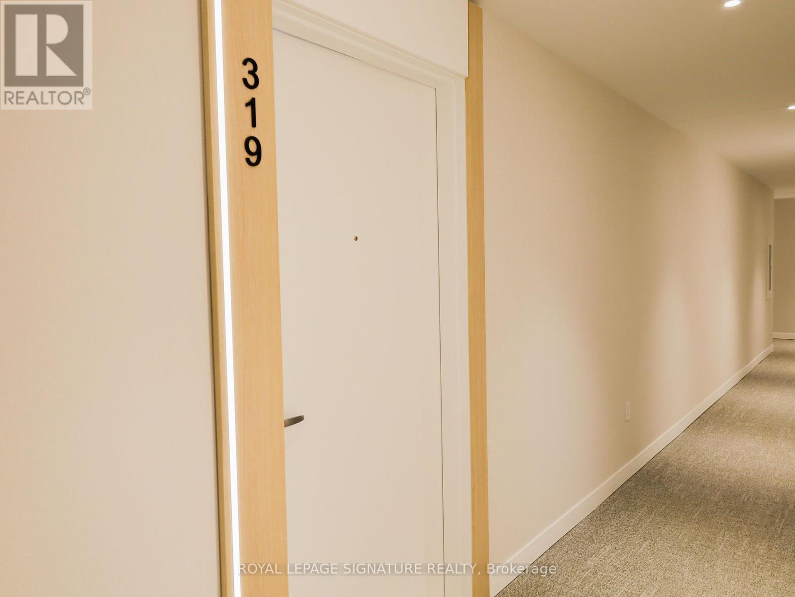 A hallway with a door and a sign that says 319.