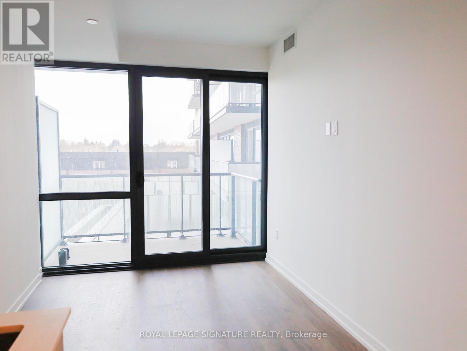A room with a sliding door and a balcony.