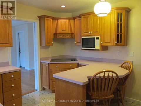 A kitchen with wooden cabinets and a white countertop.