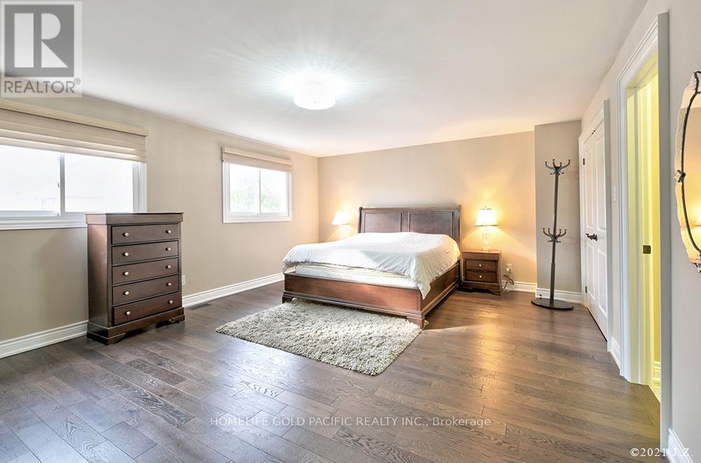 A bedroom with a bed, dresser, and nightstand.