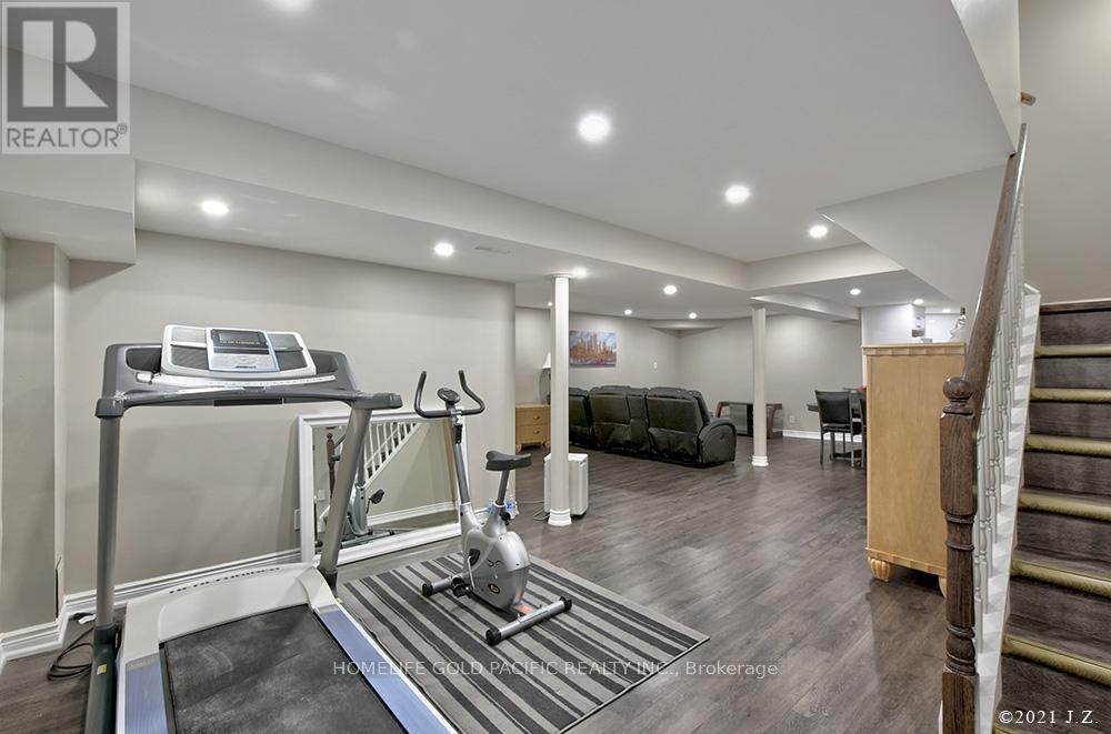A home gym with a treadmill, weights, and exercise equipment.