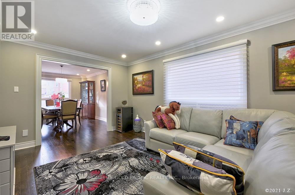 A living room with a couch, a rug, and a painting on the wall.