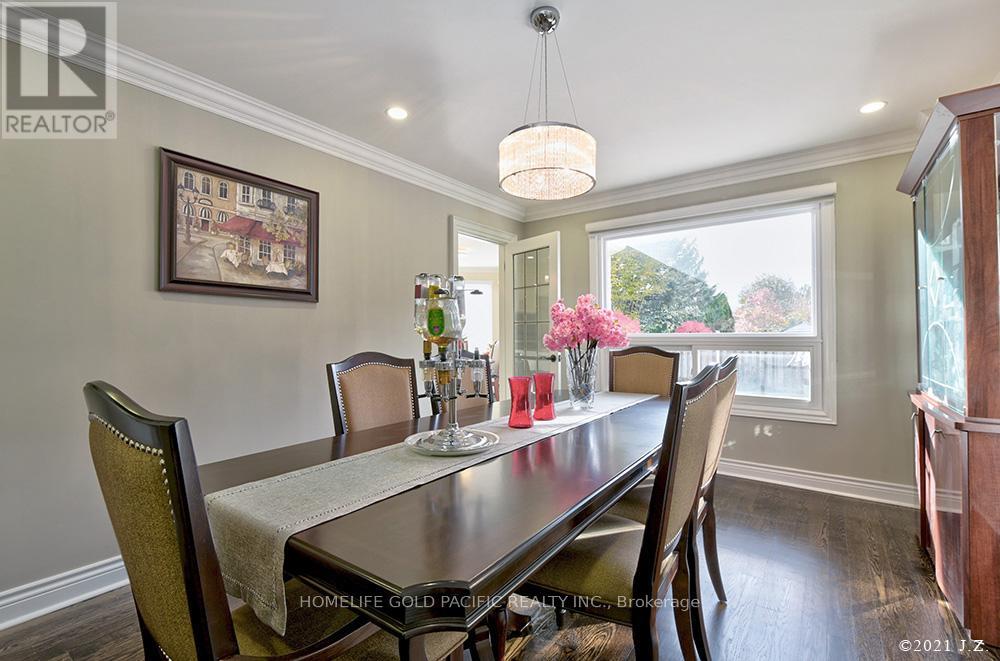 A dining room with a table set for two and a painting on the wall.