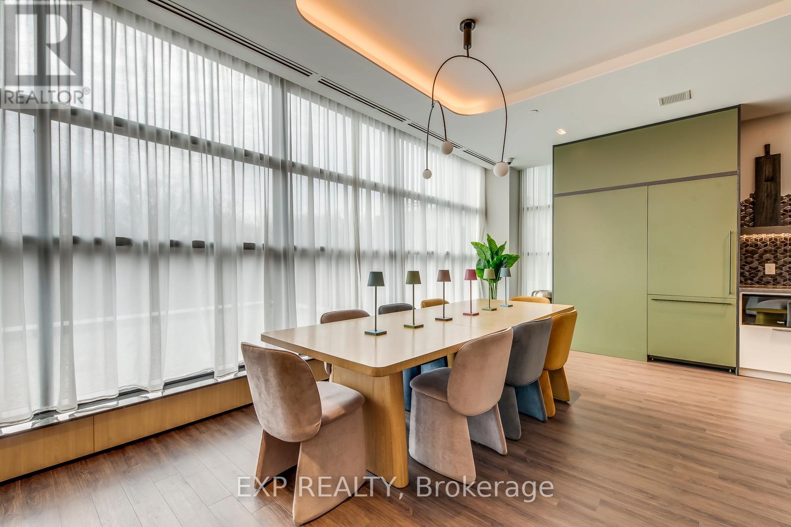 A dining room with a table and chairs.