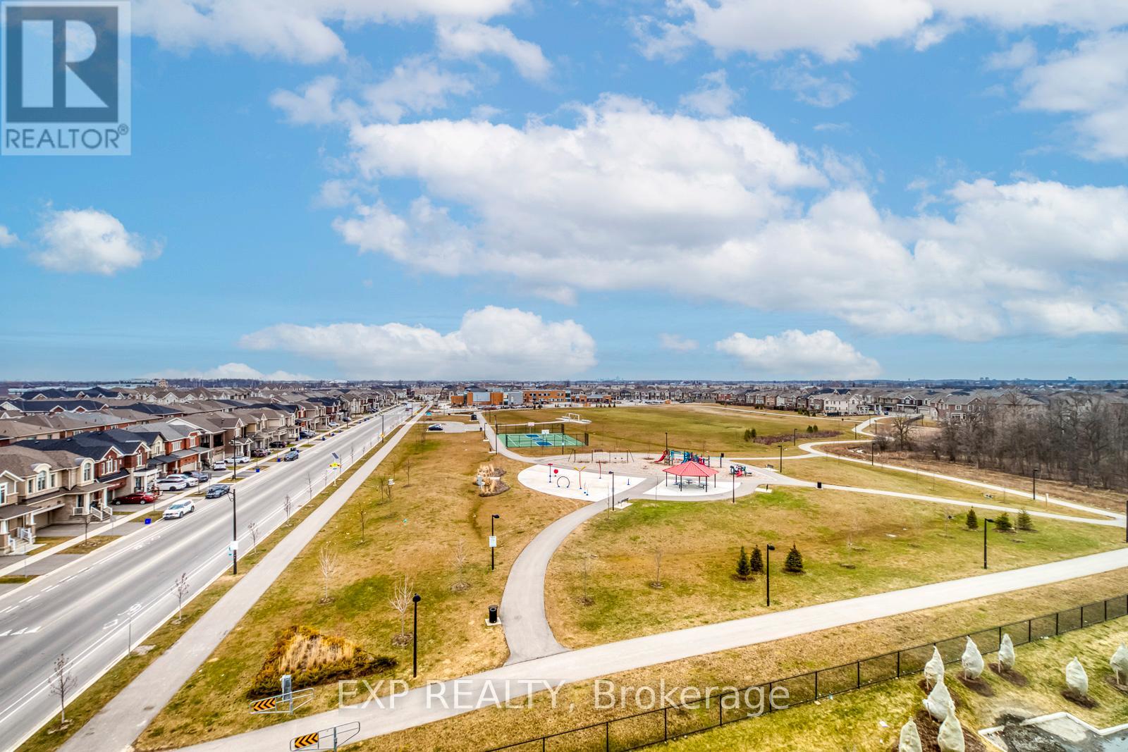 A real estate brokerage logo is displayed on a webpage featuring an aerial view of a residential area with a playground.