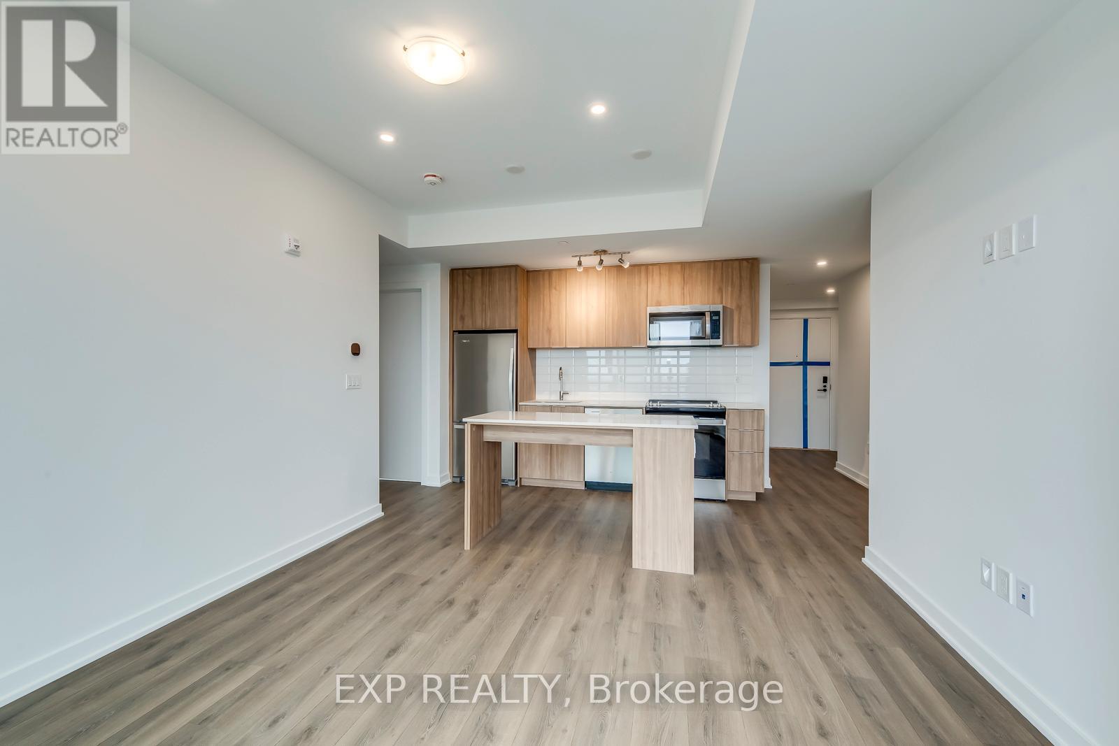A kitchen with a table and chairs in a white room.