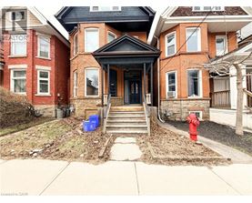 A house with a black front door and a red fire hydrant.