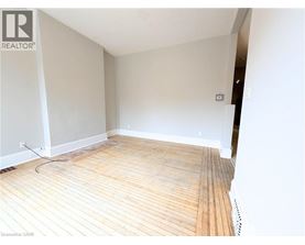 A room with wooden flooring and white walls.