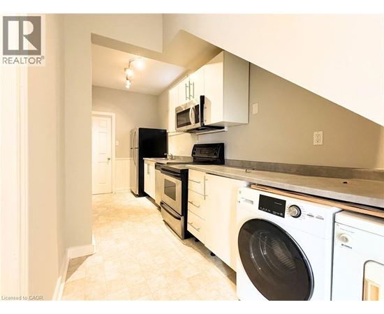 A realtor image of a kitchen with white appliances.