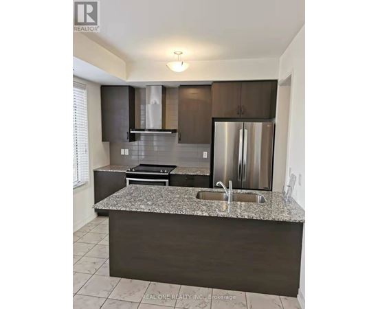 A modern kitchen with granite countertops and stainless steel appliances.
