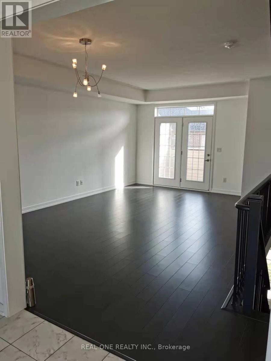 A spacious room with a chandelier and a view of a doorway.