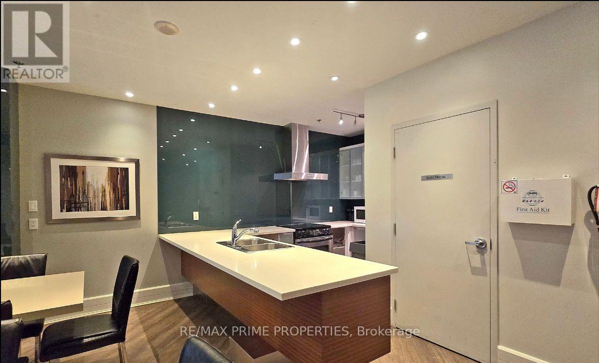 A modern kitchen with a dining table and chairs.