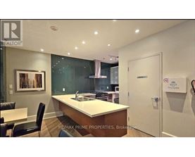 A modern kitchen with a dining table and chairs.