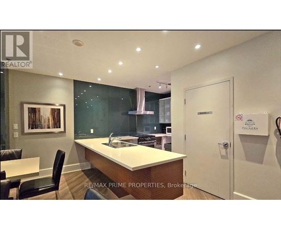 A modern kitchen with a dining table and chairs.