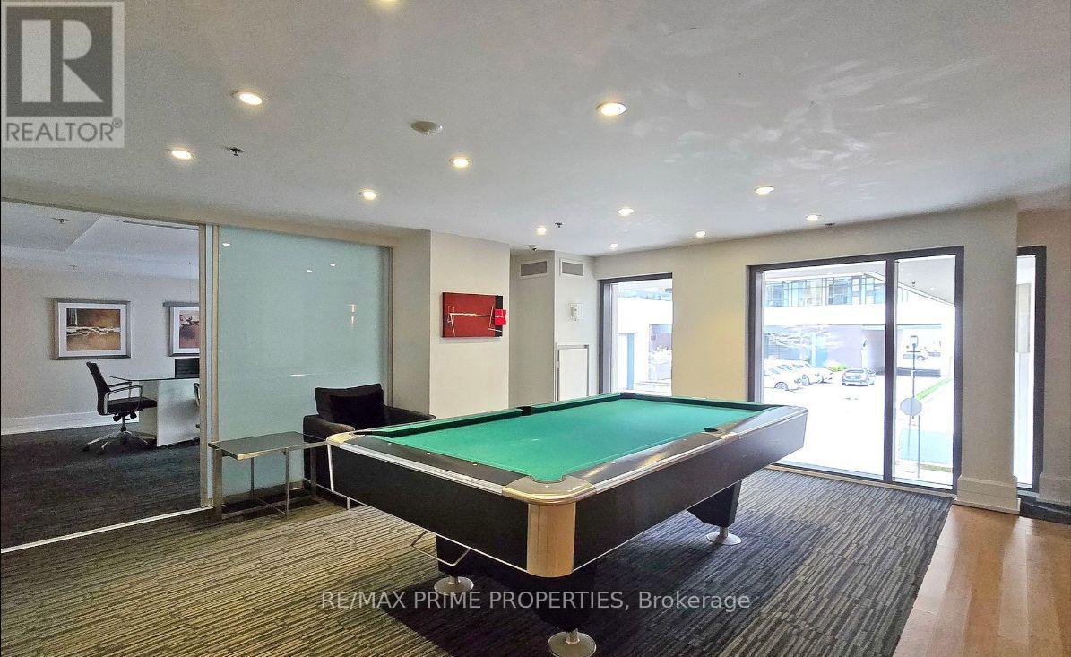 A pool table in a room with a glass wall.