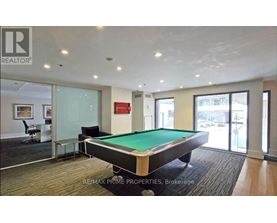 A pool table in a room with a glass wall.