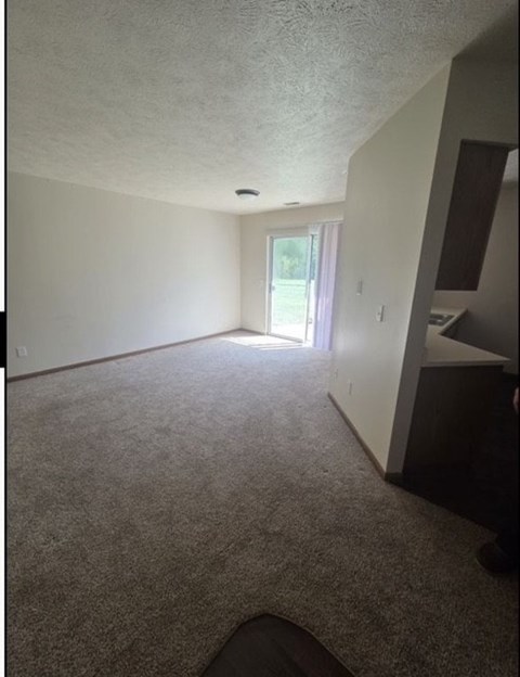 A room with a carpet floor and a window.