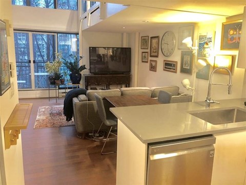 A modern kitchen with a dining table and chairs.