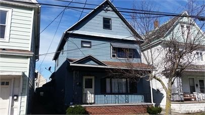 A blue house with a white door and windows.