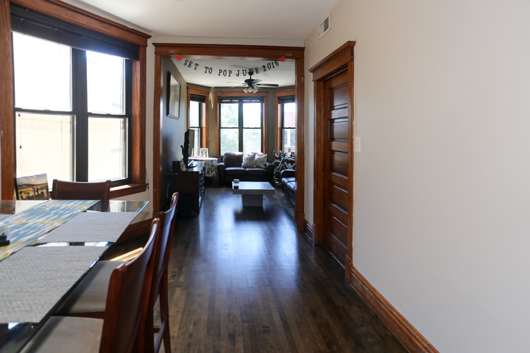 A dining room with a table and chairs.