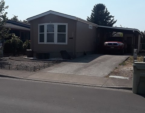 A house with a garage and a car inside.