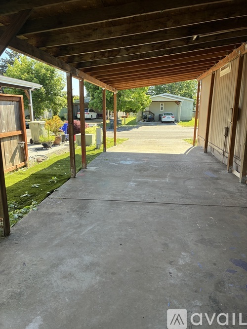 A covered walkway leads to a house with a garage.