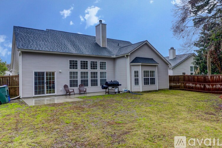 A house with a grey roof and a white exterior is available for rent.