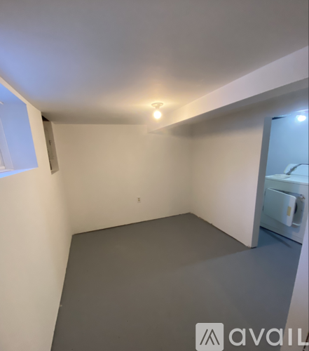 A room with a grey floor and white walls.