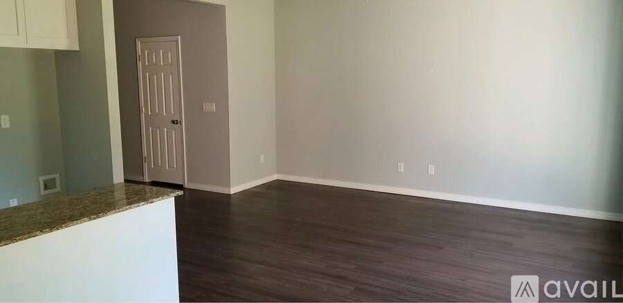 A room with a door and a counter top.