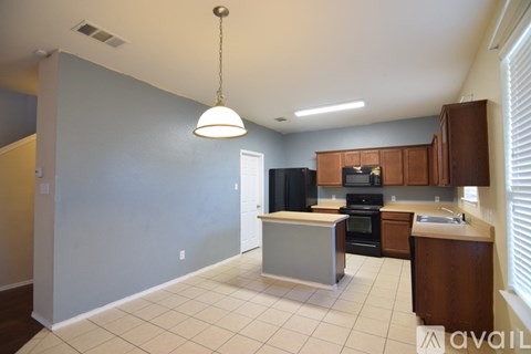 A kitchen with a black oven and microwave.