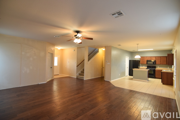 A spacious living room with a staircase leading to the upper floor.