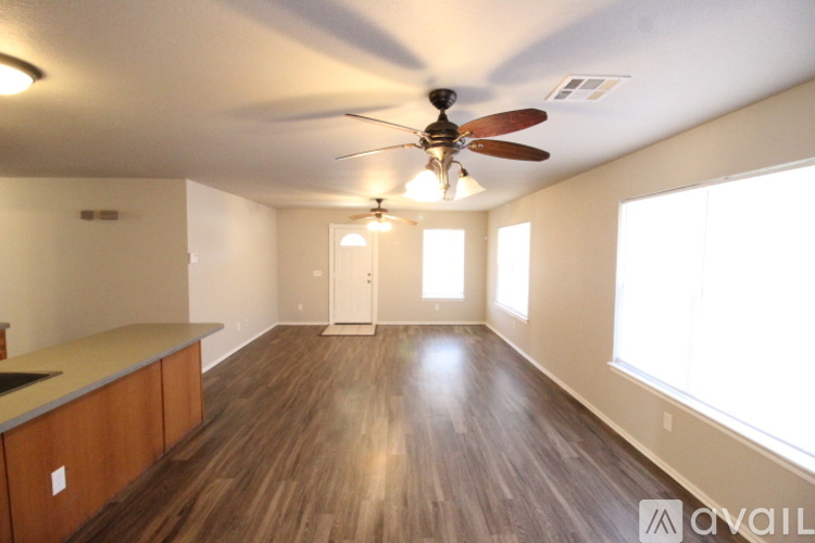A room with wooden floors and a ceiling fan.