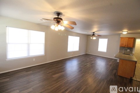 A room with wooden floors and a ceiling fan.