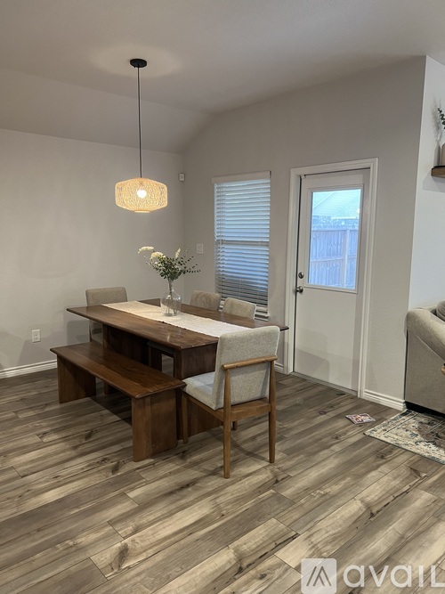 A dining room with a wooden table and chairs.