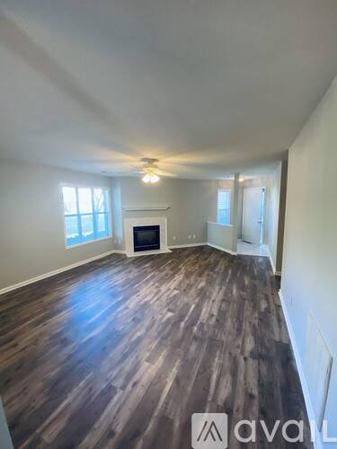 A room with wooden floors and a fireplace.