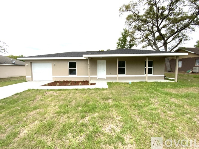 A house with a brown roof and a white garage door.