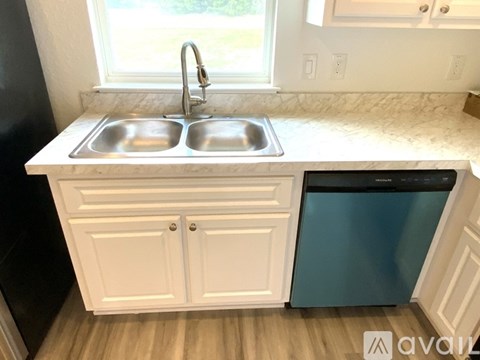 A kitchen with a sink and a window.